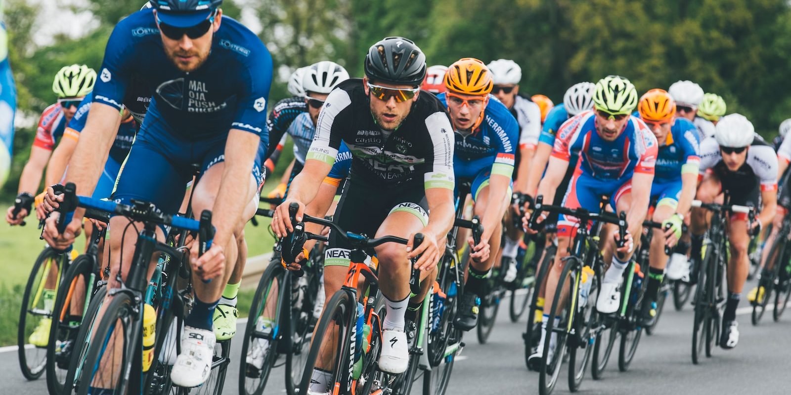 group of cyclist on asphalt road