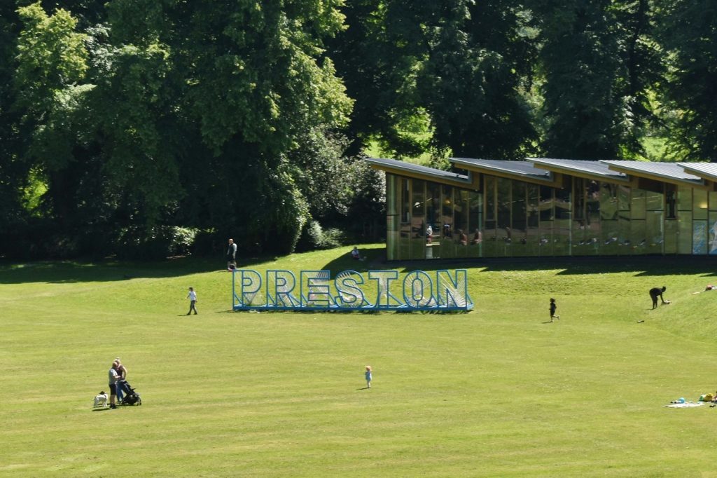 A group of people standing on top of a lush green field